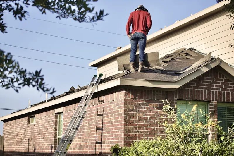 Professional roofer working on a residential roof in Kansas Corners
